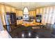 Chef's kitchen with black granite countertops, custom cabinets, island, and stainless appliances at 2660 Wyndsor Oaks Way, Winter Haven, FL 33884