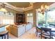 Open living area with large windows, fireplace, and elegant chandelier at 2660 Wyndsor Oaks Way, Winter Haven, FL 33884