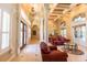 Expansive living room featuring high ceilings, elegant columns, natural light, and views leading to luxury outdoor living at 2660 Wyndsor Oaks Way, Winter Haven, FL 33884