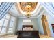 Bedroom with tray ceiling, chandelier and large windows at 2660 Wyndsor Oaks Way, Winter Haven, FL 33884