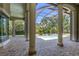 Covered patio with grand columns overlooking a serene pool and lush landscaping at 2660 Wyndsor Oaks Way, Winter Haven, FL 33884