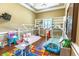Spacious playroom featuring hardwood floors, built-in shelving, and two fun house-shaped beds at 2660 Wyndsor Oaks Way, Winter Haven, FL 33884