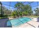 Beautiful pool area with lush tropical landscaping, perfect for relaxing or entertaining at 2660 Wyndsor Oaks Way, Winter Haven, FL 33884