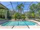 Inviting pool area surrounded by lush greenery and a screened enclosure for comfortable swimming at 2660 Wyndsor Oaks Way, Winter Haven, FL 33884