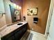 Small bathroom featuring a dark wood vanity, granite countertop, and decorative mirror at 2660 Wyndsor Oaks Way, Winter Haven, FL 33884