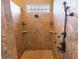 Tile shower featuring a rainfall shower head and multiple body sprayers at 2660 Wyndsor Oaks Way, Winter Haven, FL 33884