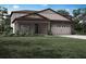 Charming two-story home with stone accents, a welcoming front porch, and attached two car garage at 3339 Chinotto Dr, Lake Alfred, FL 33850