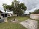 Expansive backyard with a large tree, firepit, shed, and plenty of space for outdoor activities and entertaining at 2920 Sanka Dr, Orlando, FL 32826