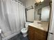 Standard bathroom featuring a tub and shower with a curtain, a single sink vanity, and a ceiling fan at 2920 Sanka Dr, Orlando, FL 32826
