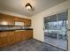 Practical kitchen features wood cabinets, neutral backsplash, and stainless steel sink under a vintage pendant light at 2920 Sanka Dr, Orlando, FL 32826