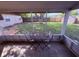 Screened patio offering an outdoor dining space and views of the spacious backyard with lots of shade at 2920 Sanka Dr, Orlando, FL 32826