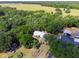 Aerial shot showcasing a home's metal roof, blending with the surrounding verdant landscape at 6702 Brookridge Trl, Lakeland, FL 33810