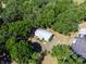 Overhead shot of a cozy home with a metal roof surrounded by mature trees and green landscape at 6702 Brookridge Trl, Lakeland, FL 33810