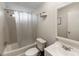Clean bathroom featuring a tub with shower, toilet, and sink with vanity at 6702 Brookridge Trl, Lakeland, FL 33810