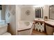 Bright bathroom featuring a corner soaking tub, vanity with sink, and decorative wall art at 6702 Brookridge Trl, Lakeland, FL 33810