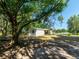 Charming single-story home with a covered porch nestled under a large shade tree at 6702 Brookridge Trl, Lakeland, FL 33810