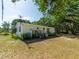 Charming home exterior with a small deck and mature landscaping in a serene setting at 6702 Brookridge Trl, Lakeland, FL 33810