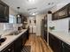 Functional kitchen with black cabinets, white countertops, stainless steel appliances, and wood flooring at 6702 Brookridge Trl, Lakeland, FL 33810