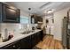 Practical kitchen with wood-look flooring, sleek black cabinets, and stainless steel appliances at 6702 Brookridge Trl, Lakeland, FL 33810