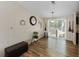 Cozy living space with wood floors, a large window for natural light, and a dining area at 6702 Brookridge Trl, Lakeland, FL 33810