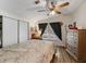 Comfortable bedroom with wood-look floors, a ceiling fan, and a closet with sliding doors at 6702 Brookridge Trl, Lakeland, FL 33810