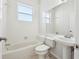Classic bathroom with a bathtub, toilet, and a pedestal sink at 1046 Island Pointe Dr, Winter Garden, FL 34787