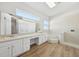 Bright bathroom boasts dual sinks, soaking tub, and a separate shower at 1046 Island Pointe Dr, Winter Garden, FL 34787