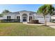 Charming one-story home featuring a manicured front lawn and a classic double-door entrance at 1046 Island Pointe Dr, Winter Garden, FL 34787