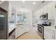 Well-lit kitchen boasting white cabinetry, stainless steel appliances, and a seamless flow to the outdoor pool area at 1046 Island Pointe Dr, Winter Garden, FL 34787