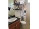 Bathroom featuring vanity, toilet, shelving and decorative shower curtain at 1415 Colonial Ct, Winter Haven, FL 33884