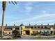 Elegant clubhouse exterior with a fountain, manicured landscaping, and golf carts at 1415 Colonial Ct, Winter Haven, FL 33884