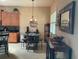 Cozy dining area featuring a stylish round table, bar seating, neutral tones and modern lighting at 1415 Colonial Ct, Winter Haven, FL 33884