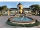 Elegant entrance to Lake Ashton community featuring a decorative fountain and manicured landscaping at 1415 Colonial Ct, Winter Haven, FL 33884