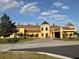 Attractive yellow building showcasing unique architectural details, a circular turret, and a welcoming entrance at 1415 Colonial Ct, Winter Haven, FL 33884