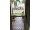 Inviting front entrance featuring a paver walkway, decorative rain chains, and manicured landscaping at 1415 Colonial Ct, Winter Haven, FL 33884