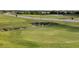 Expansive view of the golf course, showcasing lush greens and a distant street with homes at 1415 Colonial Ct, Winter Haven, FL 33884
