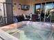 Outdoor hot tub with views of the back porch, TV, and backyard at 1415 Colonial Ct, Winter Haven, FL 33884