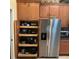 Kitchen storage featuring cabinets with pull out drawers and stainless steel refrigerator at 1415 Colonial Ct, Winter Haven, FL 33884
