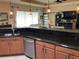Open floor plan featuring a modern kitchen, stainless appliances, dark countertops, and breakfast bar seating at 1415 Colonial Ct, Winter Haven, FL 33884