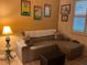 Comfortable living room with a sectional sofa, end table and unique wall art at 1415 Colonial Ct, Winter Haven, FL 33884