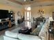 Open-concept living room with stylish furnishings, tray ceiling, and seamless flow into the dining area at 1415 Colonial Ct, Winter Haven, FL 33884