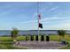 Lakeside memorial featuring the American flag at half-mast and commemorative plaques at 1415 Colonial Ct, Winter Haven, FL 33884