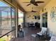 Enclosed patio with ceiling fans, dining set, and decorative nautical decor, perfect for entertaining and relaxing at 1415 Colonial Ct, Winter Haven, FL 33884