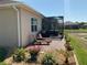 Outdoor patio featuring brick pavers, a screened-in area, hot tub, and relaxing seating at 1415 Colonial Ct, Winter Haven, FL 33884