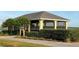 Community yellow pavilion with ample seating and screened in views of the water, framed by lush landscaping at 1415 Colonial Ct, Winter Haven, FL 33884