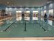 Spacious indoor pool featuring marked lanes, volleyball net, and plenty of natural light from surrounding windows at 1415 Colonial Ct, Winter Haven, FL 33884