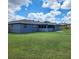 Backyard features a well-maintained lawn and a screened-in porch at 8804 Harrison Rd, Lakeland, FL 33810