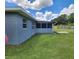 Backyard features a well-maintained lawn and a screened-in porch at 8804 Harrison Rd, Lakeland, FL 33810