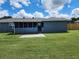 Spacious backyard featuring a well-maintained lawn, screened in porch, and a patio at 8804 Harrison Rd, Lakeland, FL 33810