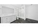 Modern bathroom featuring double vanity, glass enclosed shower, and dark tile floors at 8804 Harrison Rd, Lakeland, FL 33810